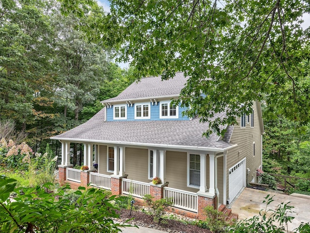 farmhouse inspired home with a garage and covered porch