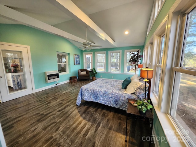 bedroom with lofted ceiling, multiple windows, heating unit, and wood finished floors