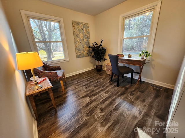 office featuring dark wood-type flooring, visible vents, and baseboards