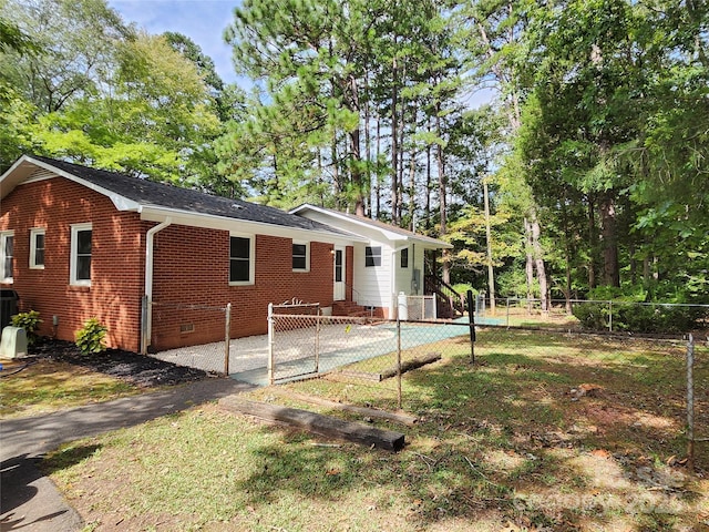 exterior space with crawl space, brick siding, fence, and central air condition unit