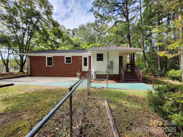 back of house featuring crawl space, a patio area, a yard, and brick siding