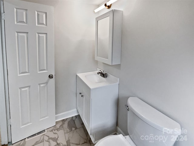 bathroom featuring vanity and toilet