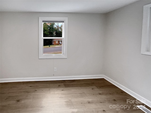 empty room with hardwood / wood-style flooring