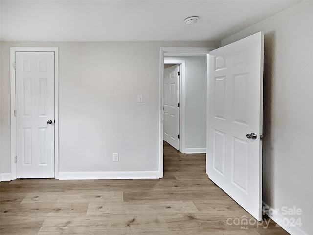 unfurnished room with light wood-type flooring