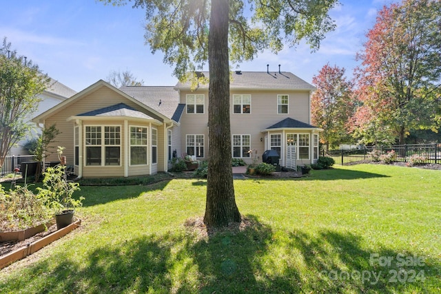 rear view of house with a yard