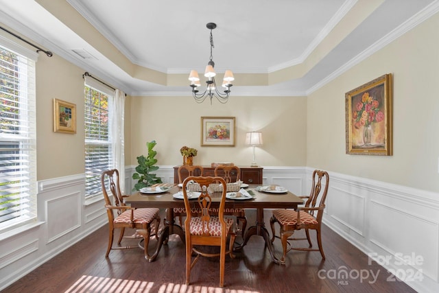 dining room featuring ornamental molding, dark wood-type flooring, and a tray ceiling