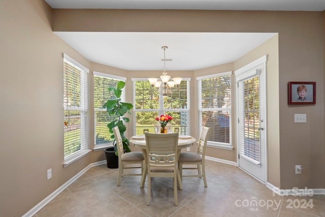 dining area featuring a wealth of natural light, a chandelier, and light tile patterned floors