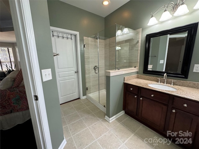 bathroom featuring vanity, walk in shower, and tile patterned flooring