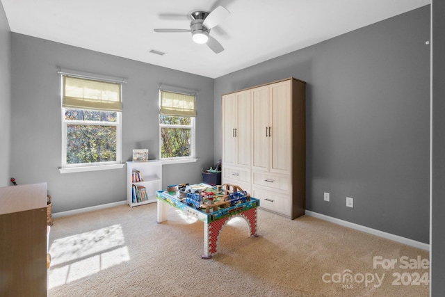 playroom with light colored carpet and ceiling fan