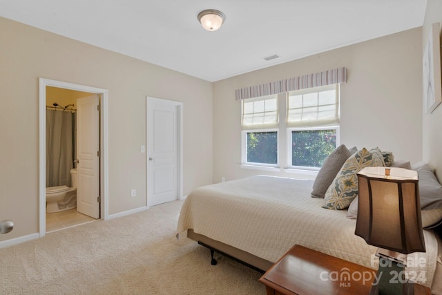 carpeted bedroom with ensuite bath