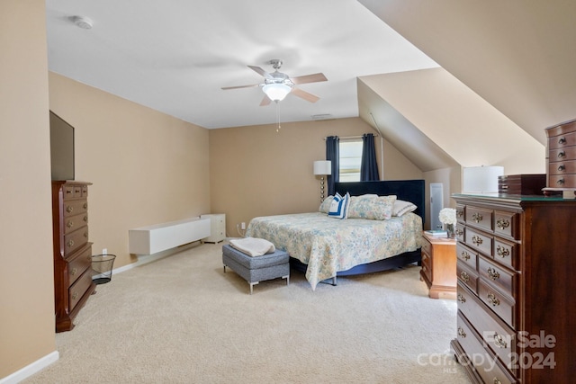 bedroom with ceiling fan, vaulted ceiling, and light colored carpet