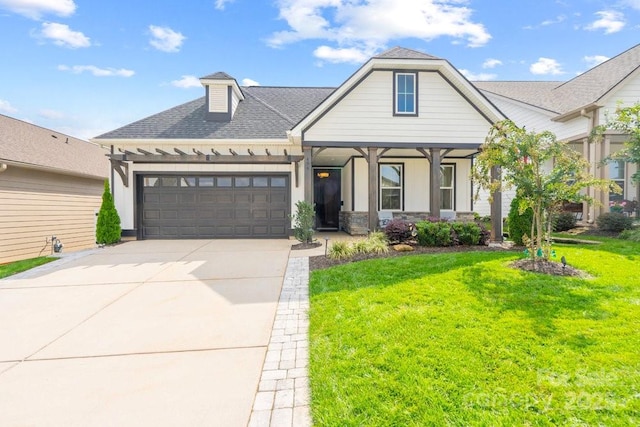 view of front of property with a front yard and a garage