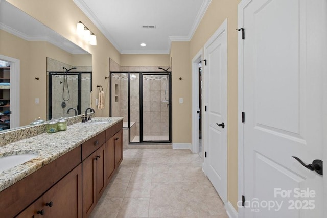 bathroom with tile patterned flooring, vanity, crown molding, and a shower with shower door