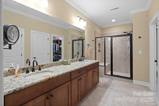 bathroom with tile patterned floors, crown molding, vanity, and walk in shower