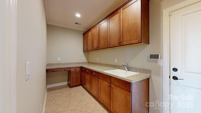 kitchen with light stone counters and sink