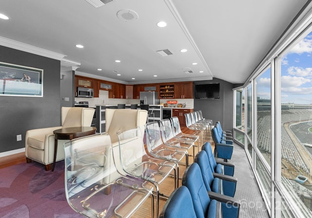 interior space featuring lofted ceiling and ornamental molding