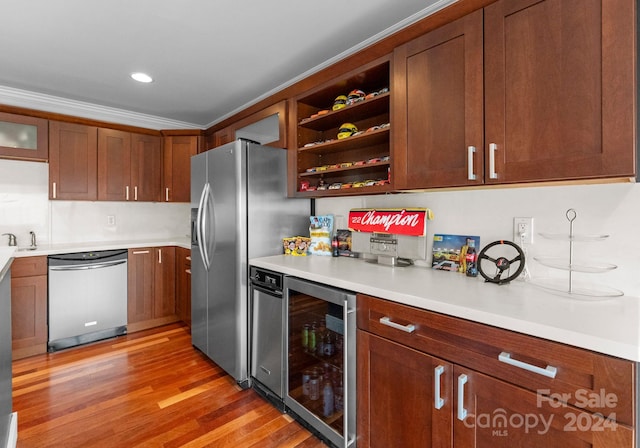 kitchen with wine cooler, light hardwood / wood-style floors, sink, stainless steel appliances, and crown molding