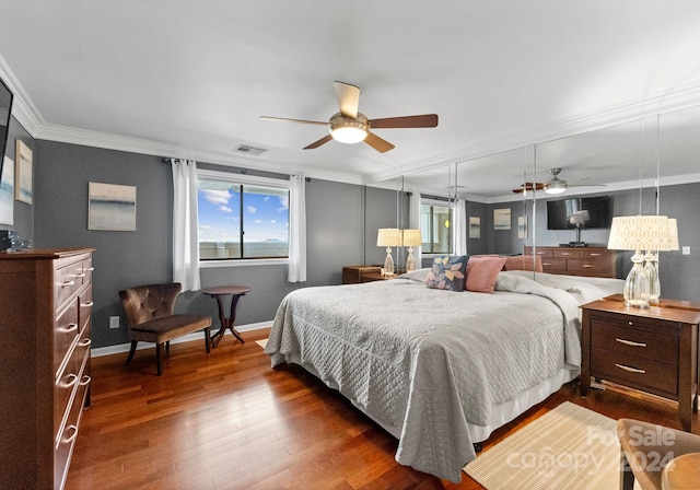 bedroom featuring crown molding, ceiling fan, and dark wood-type flooring