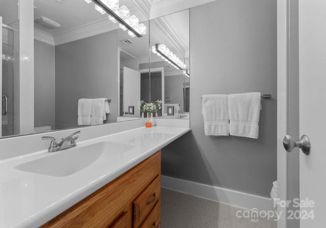 bathroom featuring ornamental molding, vanity, toilet, and an enclosed shower