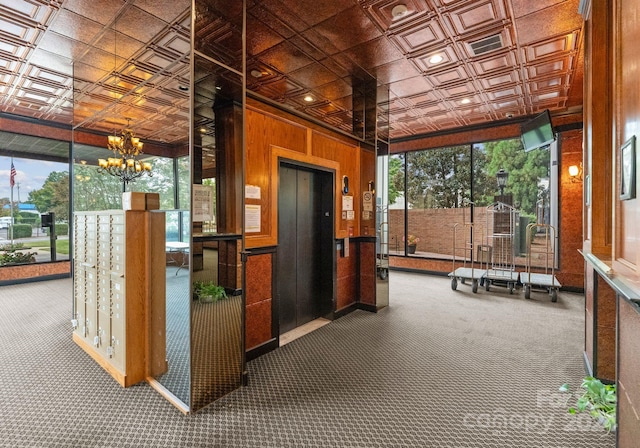 interior space featuring carpet flooring, a chandelier, elevator, and a healthy amount of sunlight