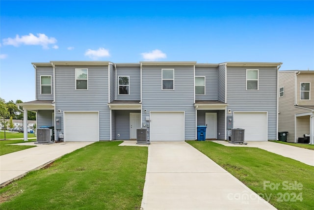 view of property featuring a garage and central air condition unit