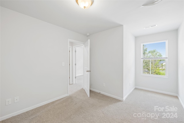 unfurnished bedroom with light colored carpet