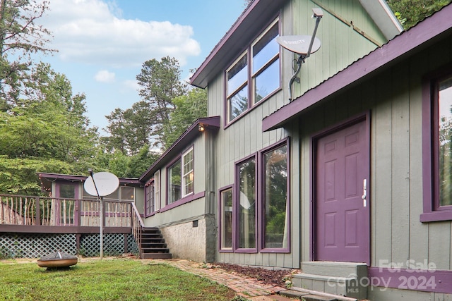 exterior space with a lawn and a deck