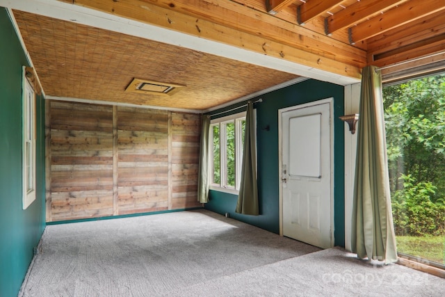 interior space with beamed ceiling and wooden walls