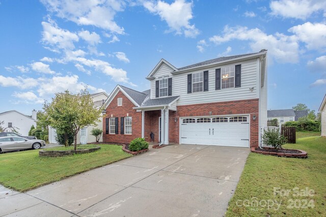 front facade with a front lawn and a garage