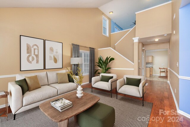 living room featuring hardwood / wood-style flooring and high vaulted ceiling