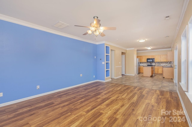 unfurnished living room with light hardwood / wood-style floors, ornamental molding, sink, and ceiling fan