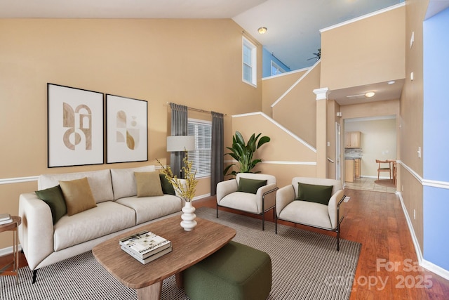 living room with ceiling fan, high vaulted ceiling, and wood-type flooring