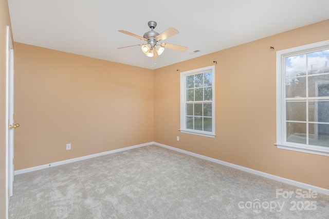 carpeted spare room with ceiling fan