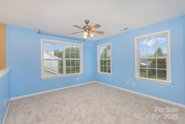 empty room with ceiling fan and carpet