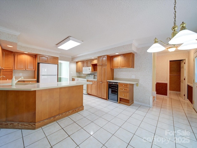 kitchen with crown molding, white appliances, beverage cooler, and decorative light fixtures