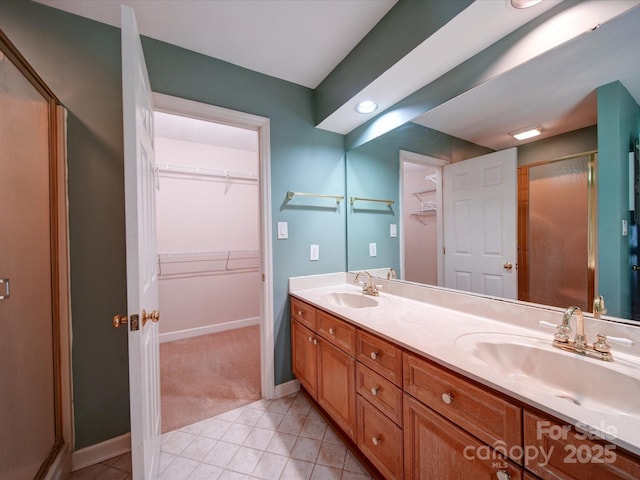 bathroom with tile patterned flooring, vanity, and a shower with shower door