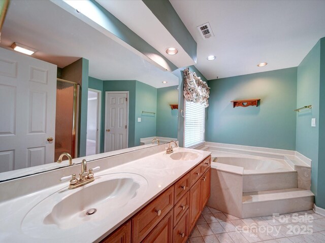 bathroom with tile patterned flooring, vanity, and shower with separate bathtub