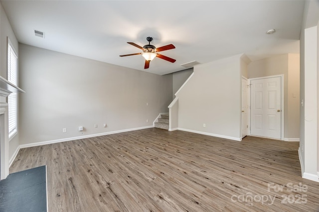 unfurnished living room with hardwood / wood-style flooring and ceiling fan