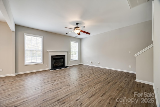 unfurnished living room with hardwood / wood-style flooring and ceiling fan