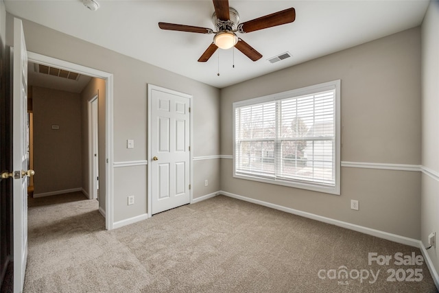 unfurnished bedroom featuring light carpet and ceiling fan