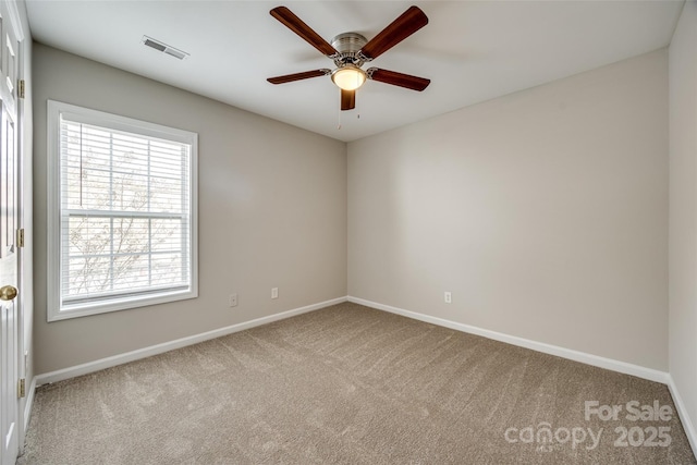 empty room featuring ceiling fan and light carpet