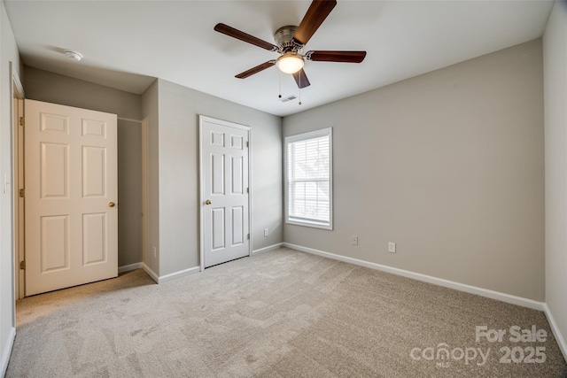 unfurnished bedroom featuring ceiling fan and light colored carpet