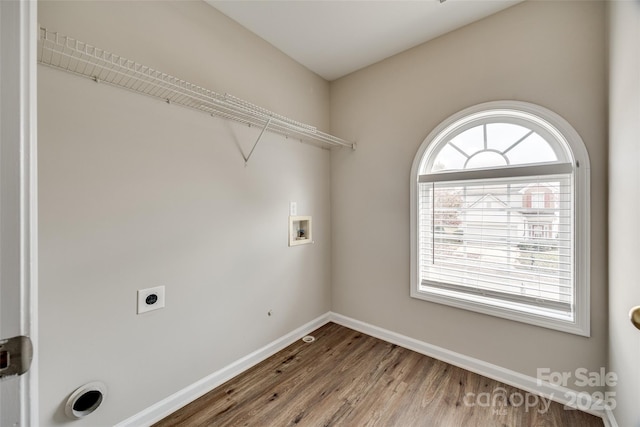 clothes washing area with hardwood / wood-style flooring, washer hookup, and electric dryer hookup