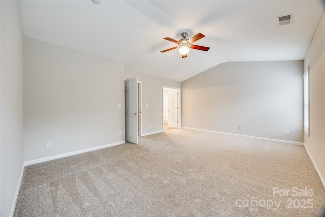 carpeted empty room featuring lofted ceiling and ceiling fan