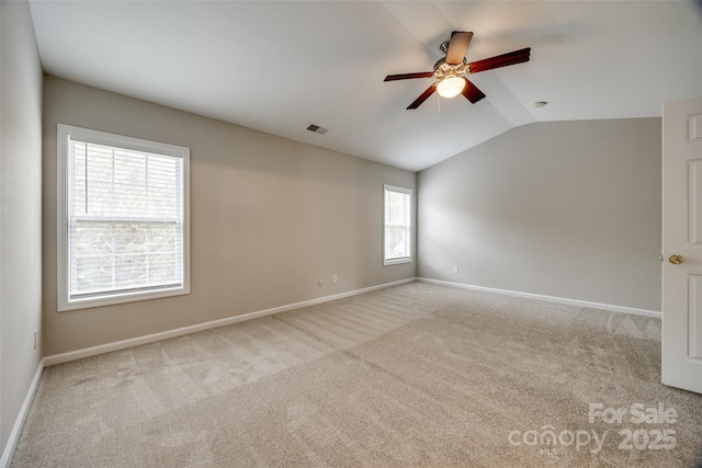 carpeted empty room featuring ceiling fan and lofted ceiling