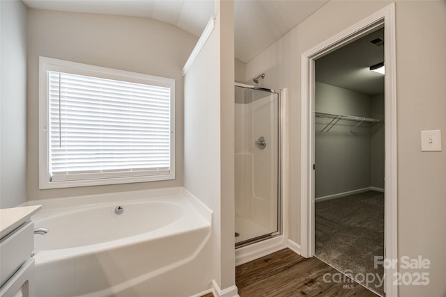 bathroom featuring vanity, hardwood / wood-style flooring, and independent shower and bath