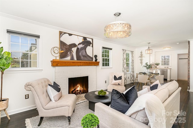 630 S Myrtle School Rd, Gastonia, NC 28052 - living area with ornamental molding, a notable chandelier, baseboards, and dark wood-type flooring