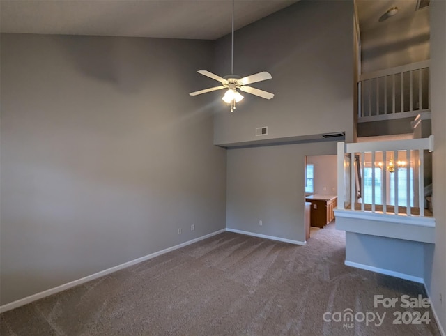 unfurnished room featuring high vaulted ceiling, carpet, and ceiling fan