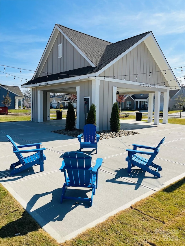 view of property's community featuring a lawn and a patio