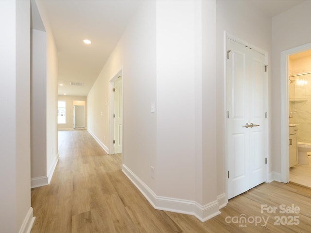 hallway featuring recessed lighting, visible vents, light wood-style flooring, and baseboards